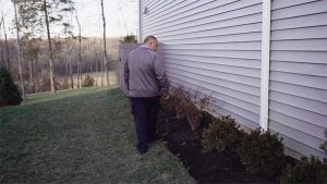 Pest Tech checking for outdoor pest